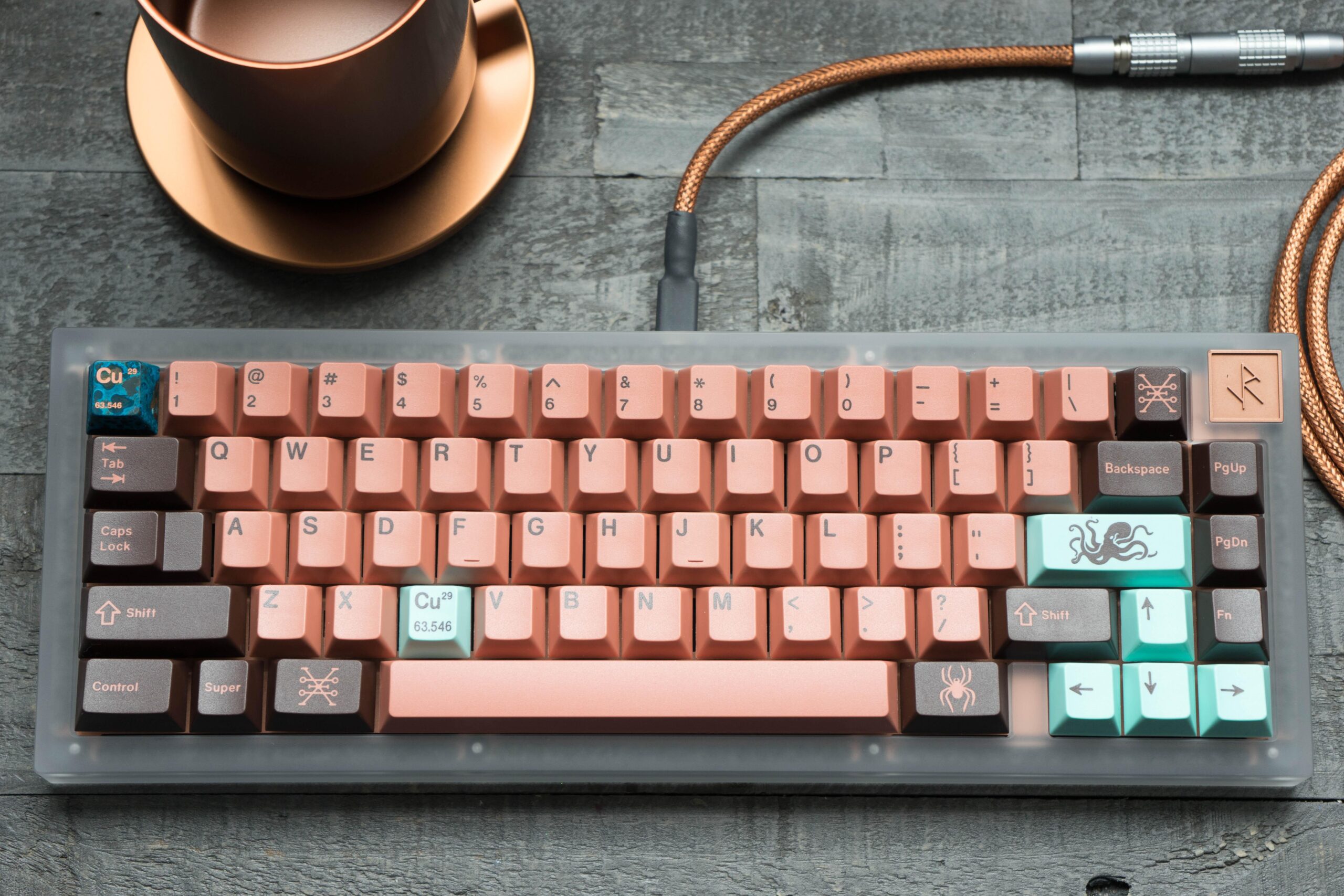 Copper Keycaps set keyboard with teal, pastel pink and gray tones. Nice usb custom cable and other matching elements on the table
