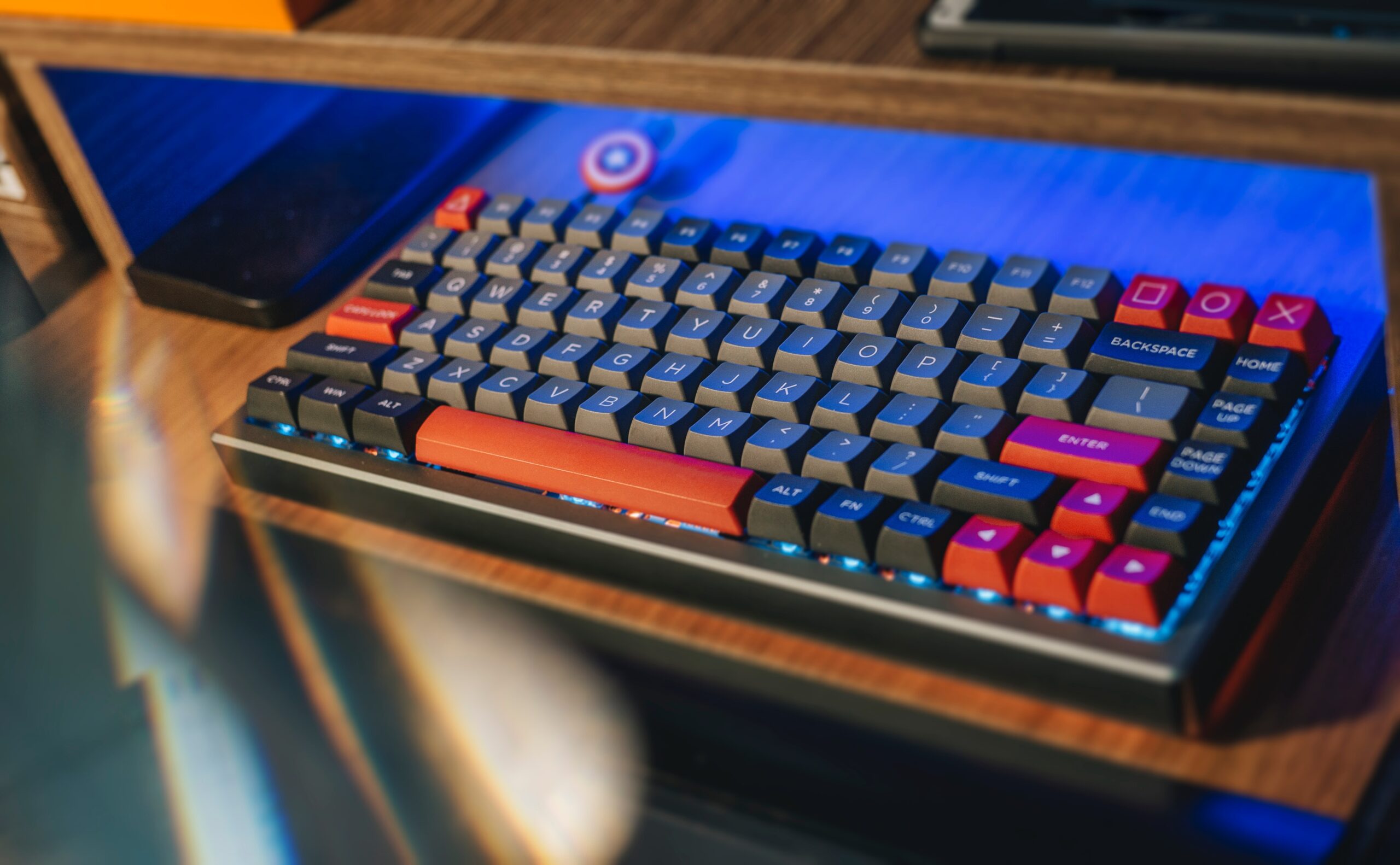 Mechanical Keyboard on a desk with black, gray and orange keycaps